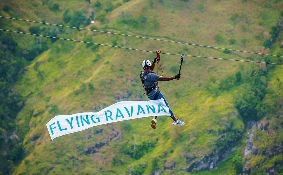 A rider on the Flying Ravana Mega Zipline crossing above the tea slopes at Ella